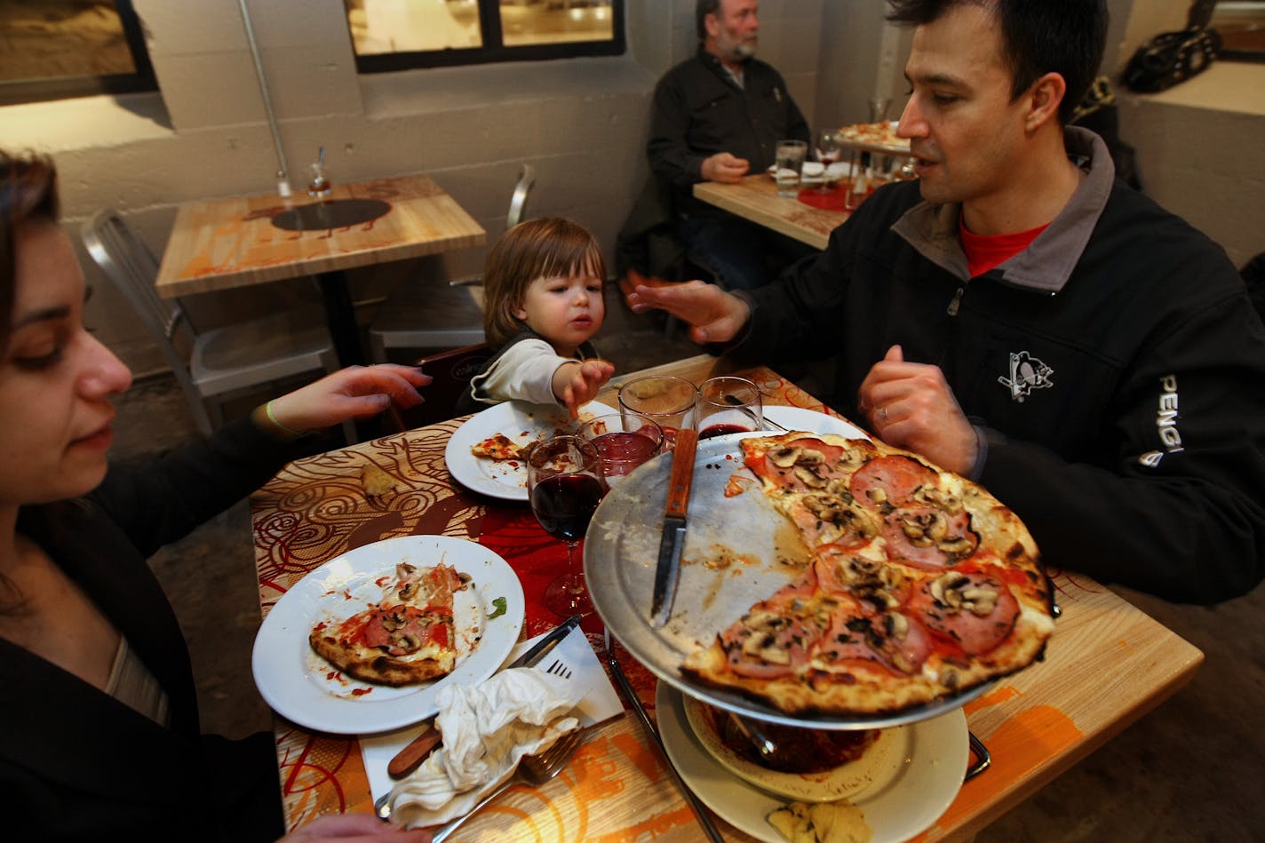 From left, Ayse Tutek, Leonidas (Leo) Paraskevas and Cristo Paraskevas live in the neighborhood and visit Black Sheep Pizza often.