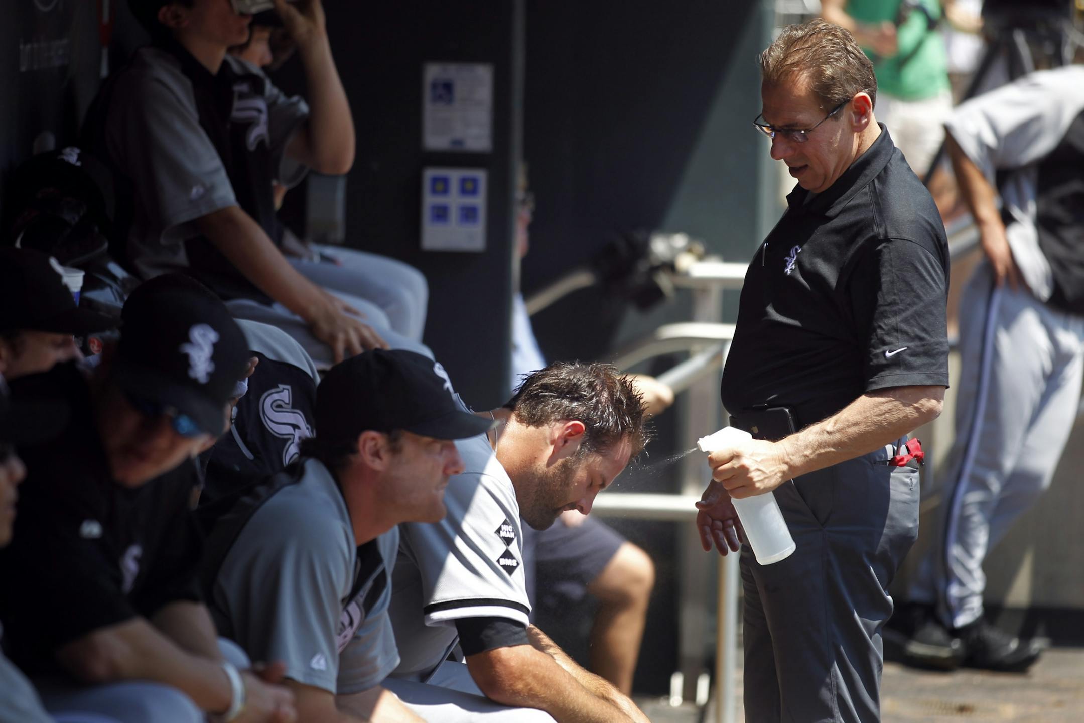 White Sox Jordan Danks was sprayed with waterby tranier Herm Schneider trying to keep cool between innings of the Minnesotan Twins and Chicago White Sox game at Target Field Wednesday June 27, 2012 in Minneapolis, MN.