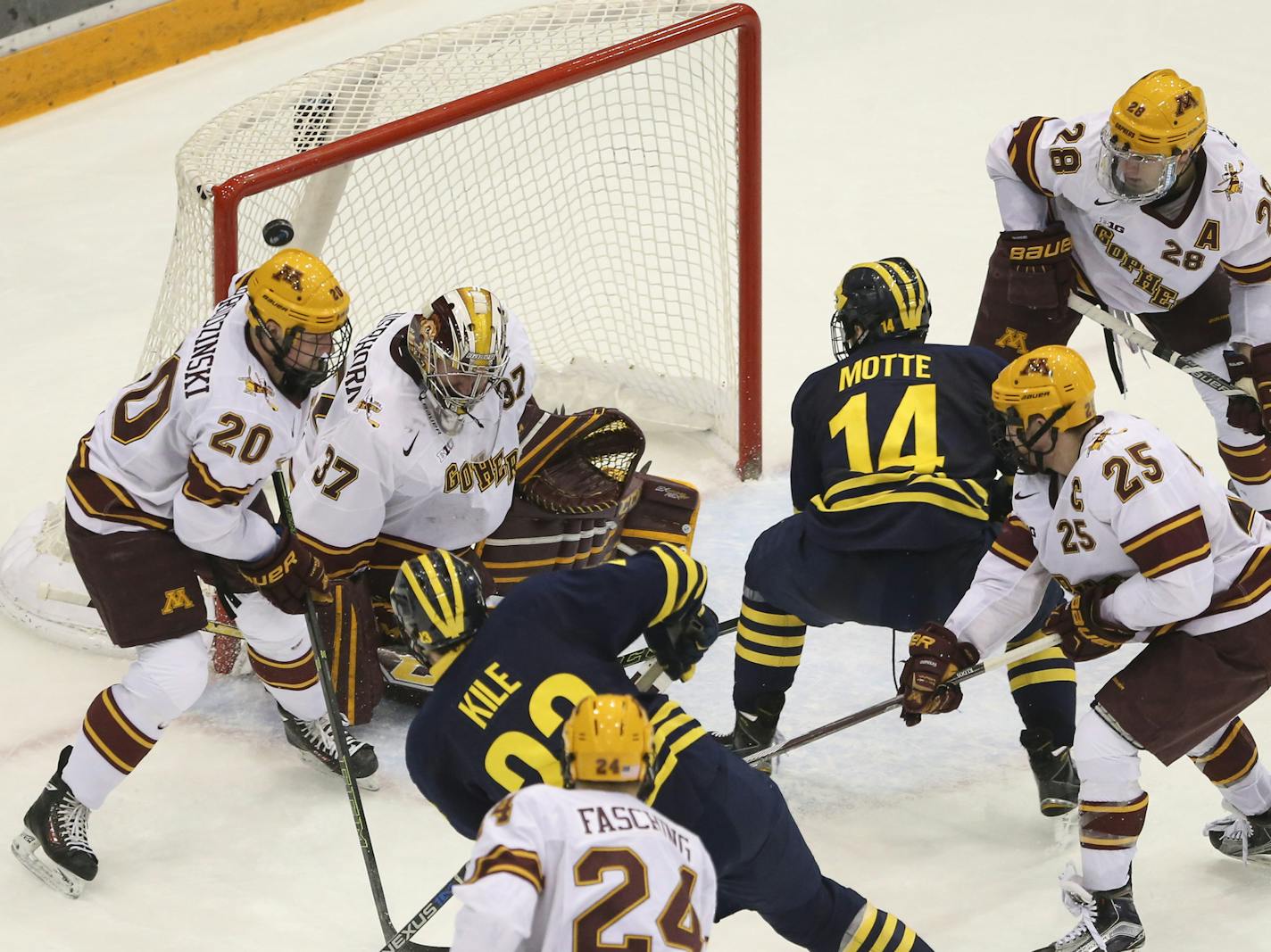 Wolverines forward Alex Kile (23) scored his second goal of the game on this second period shot over the right shoulder of Gophers goalie Eric Schierhorn in the second period. ] JEFF WHEELER &#xef; jeff.wheeler@startribune.com The University of Minnesota men's hockey team faced the University of Michigan Thursday night, February 25, 2016 at Mariucci Arena in Minneapolis.