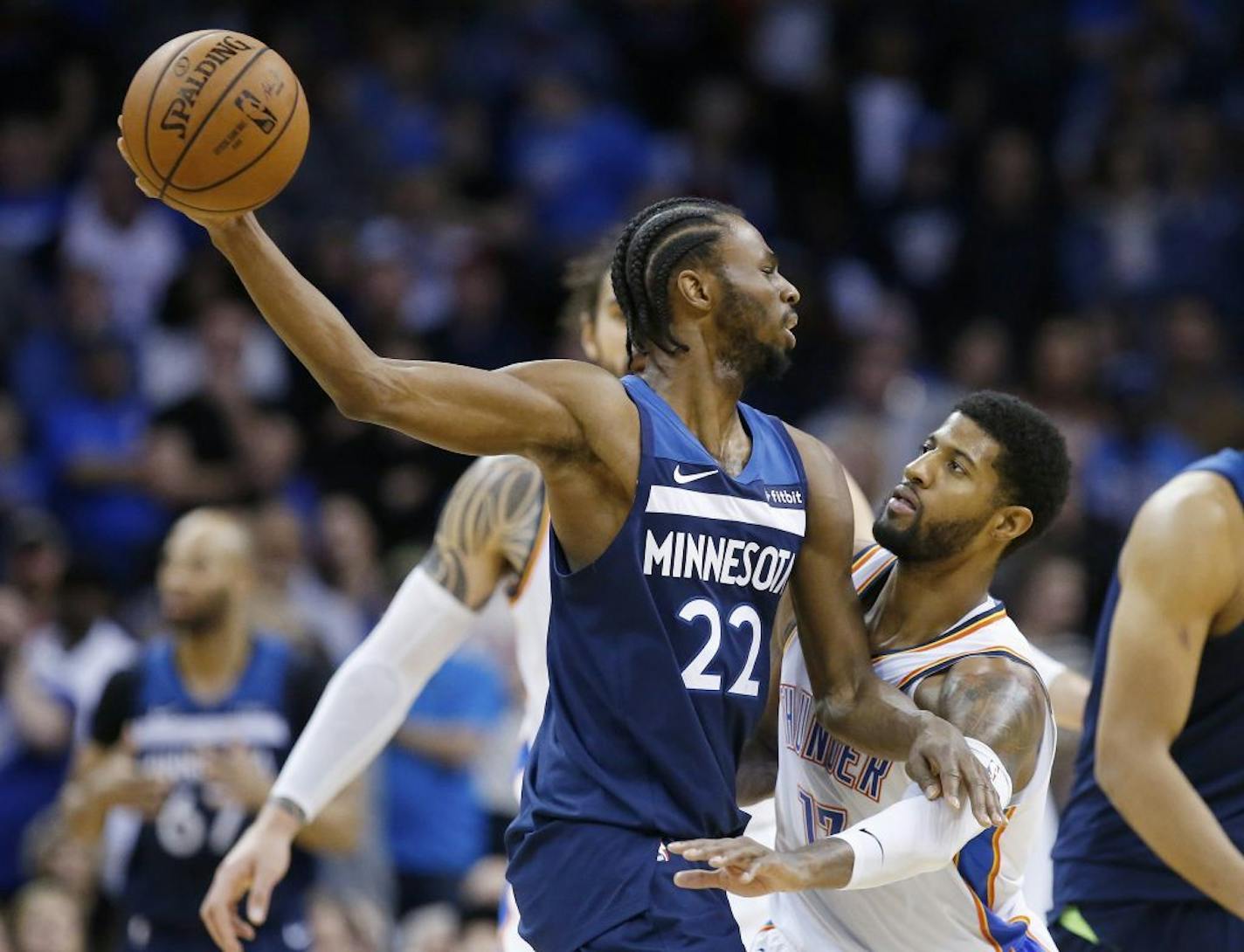 Oklahoma City Thunder forward Paul George, right, defends Minnesota Timberwolves forward Andrew Wiggins (22) in the second half of an NBA basketball game in Oklahoma City, Tuesday, Jan. 8, 2019.