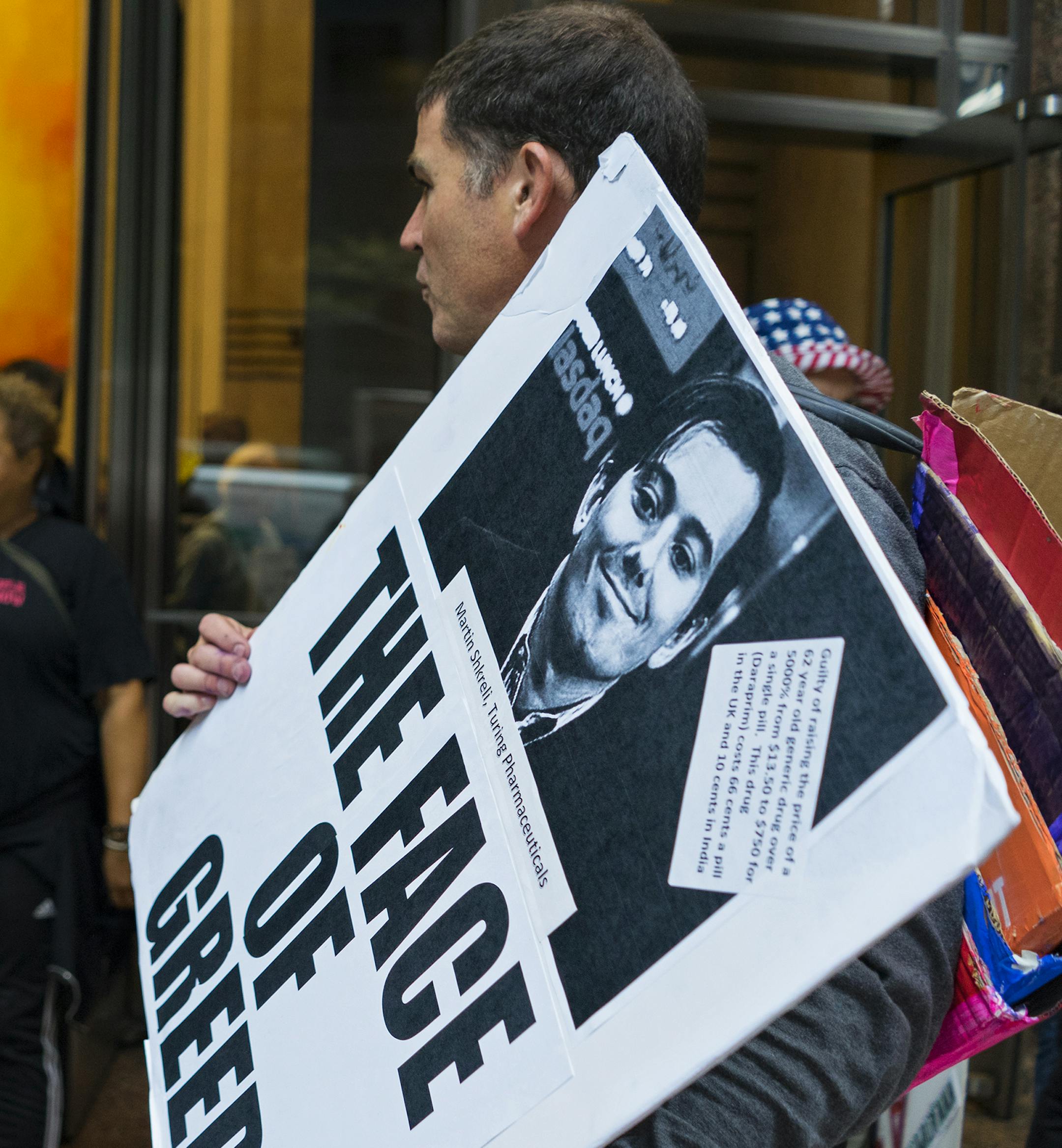 Activists hold signs containing the image of Turing Pharmaceuticals CEO Martin Shkreli in front the building that houses Turing's offices, in New York, Thursday, Oct. 1, 2015, during a protest highlighting pharmaceutical&#x2020;drug pricing. Turing Pharmaceuticals&#x2020;sparked an angry backlash last month after it raised the price of&#x2020;Daraprim, the only approved treatment for a rare, life-threatening parasitic infection, by more than 5,000 percent. (AP Photo/Craig Ruttle)