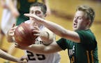 Springfield's Kale Meandering, left, and Nevis' Zach Henry battled for the ball during the second period of their match up of the boys' basketball Cla