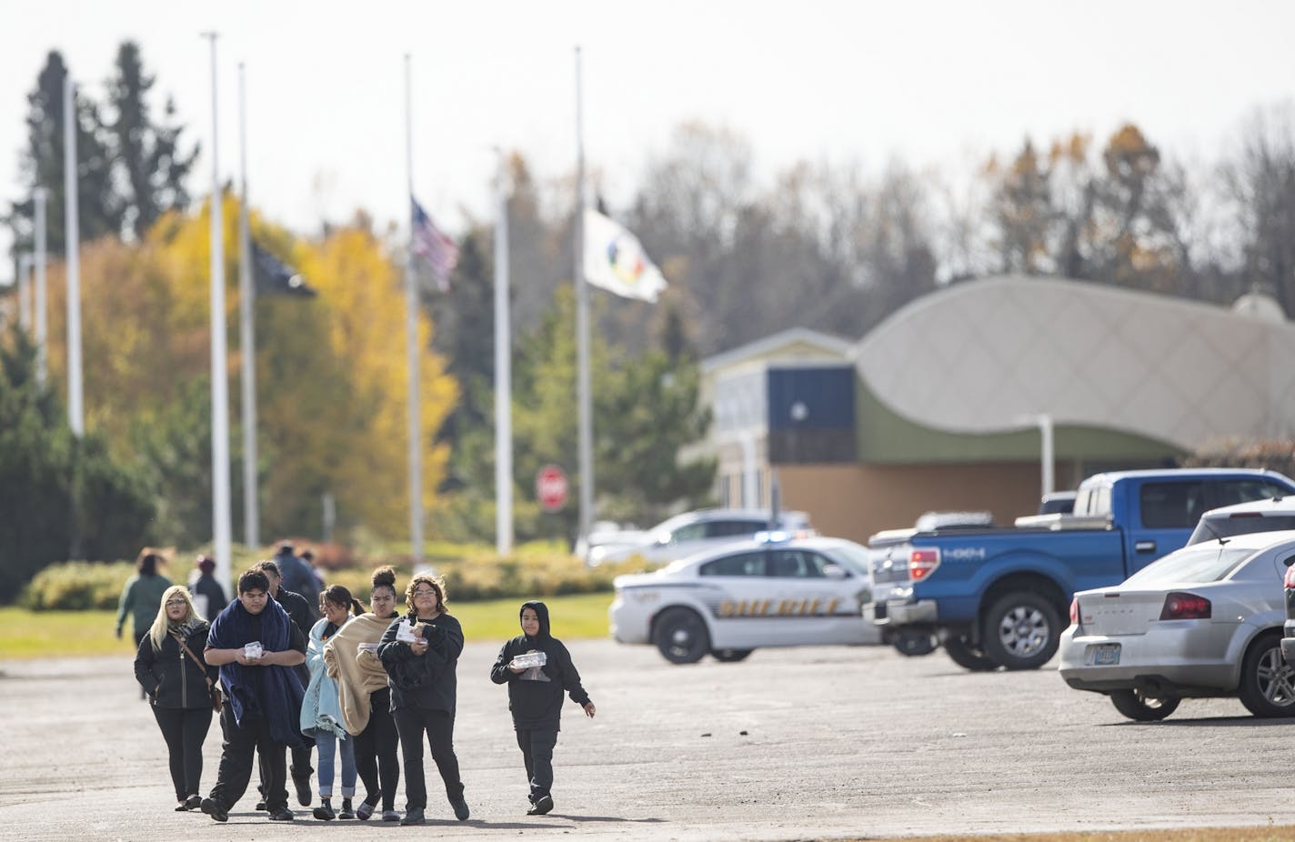 People walked away from the community center in Fond Du Lac after the lock down was lifted. The gymnasium inside is where a man was shot in the head only two hours earlier.