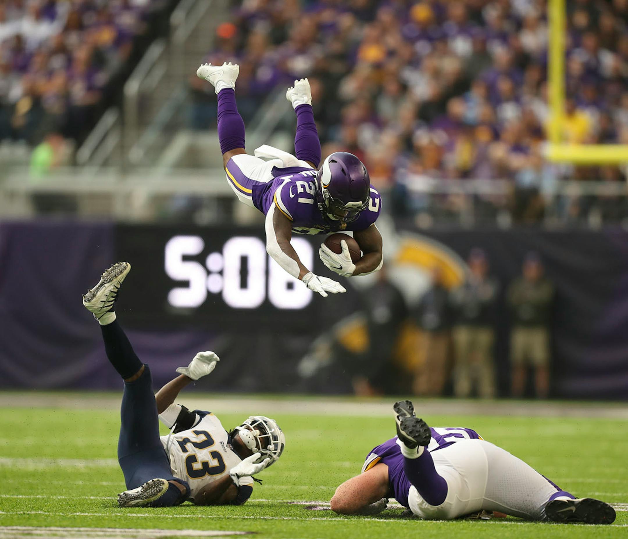 Minnesota Vikings running back Jerick McKinnon went high when Los Angeles Rams cornerback Nickell Robey-Coleman (23) went low on a tackle after McKinnon gained 15 yards on a short pass in the firs quarter.