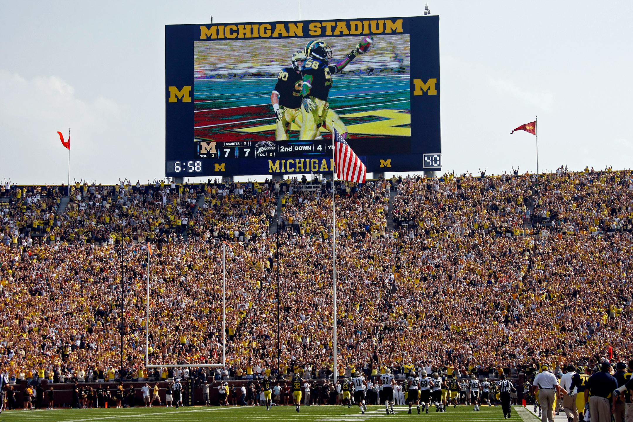 Michigan linebacker Brandon Herron (58), shown on the Michigan Stadium video scoreboard, runs in an interception for a touchdown in the second quarter of an NCAA college football game with Western Michigan, Saturday, Sept. 3, 2011, in Ann Arbor, Mich. (AP Photo/Tony Ding)