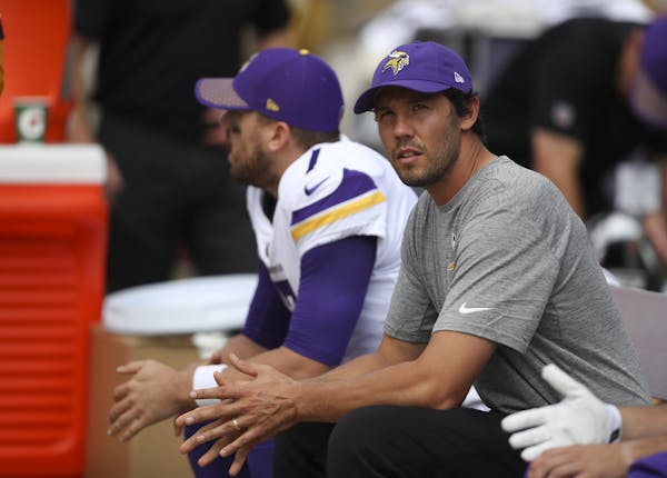 Injured Vikings quarterback Sam Bradford, right, sat on the bench with his backup, Case Keenum, during the Steelers' first series Sunday.