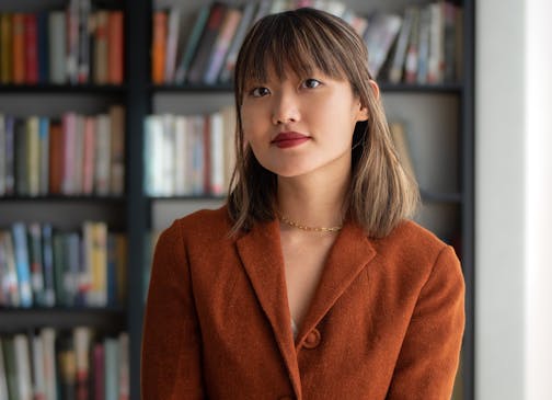 photo of author Katie Yee in front of bookcases