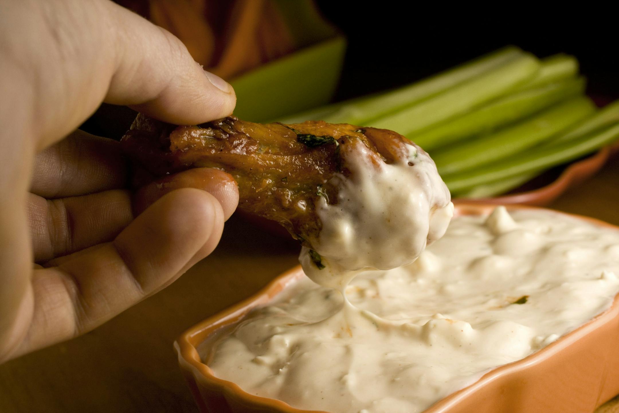 Cooking the chicken wings once at a lower temperature, then again at a high temperature yields a fully cooked wing with a crisp skin.