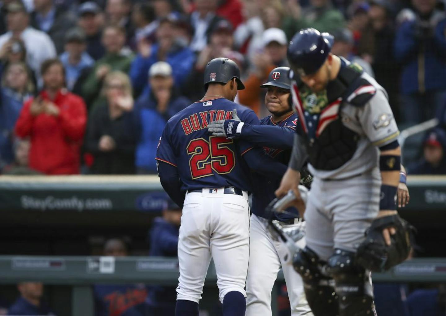 Minnesota Twins center fielder Byron Buxton was congratulated by Luis Arraez after he knocked a three run homer to left center iin May.