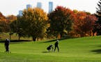 Husband and wife Gordan, left, and Jan Beavers of Golden Valley picked a nearly perfect fall day for golf as fall foliage was near its peak colors Wed