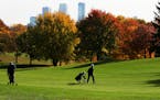 Husband and wife Gordan, left, and Jan Beavers of Golden Valley picked a nearly perfect fall day for golf as fall foliage was near its peak colors Wed
