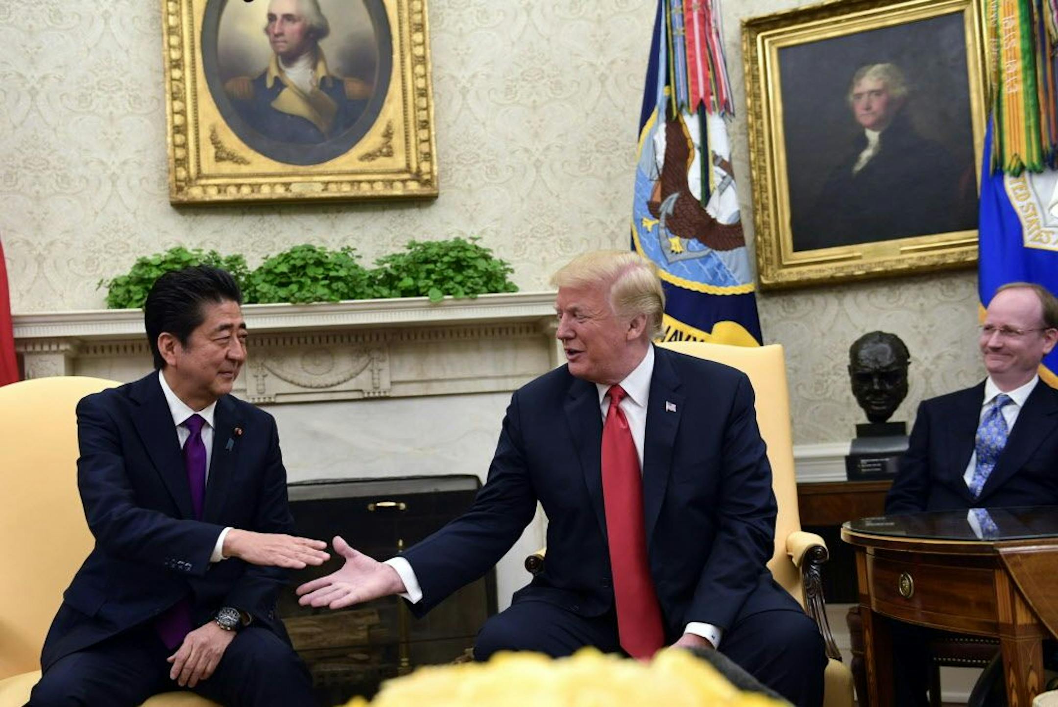 President Donald Trump, second from right, shakes hands with Japanese Prime Minister Shinzo Abe, left, in the Oval Office of the White House in Washington, Thursday, June 7, 2018.