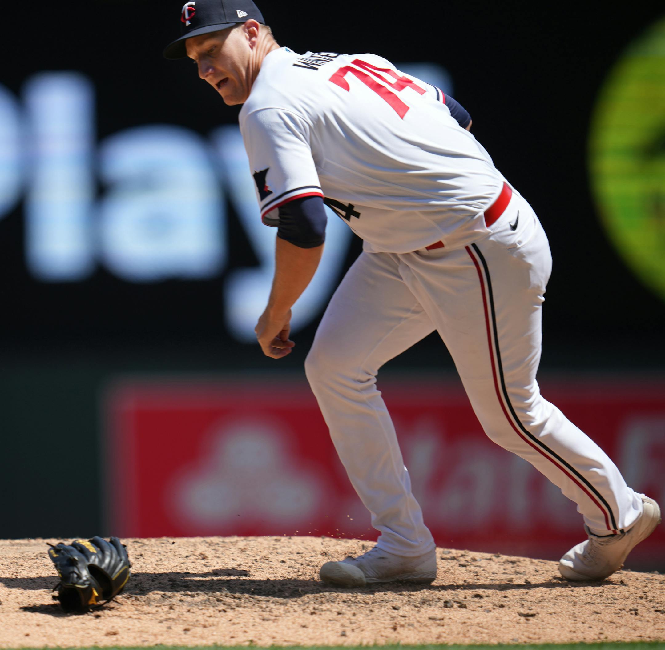 Minnesota Twins pitcher Josh Winder(74) momentarily loses the glove and ball but throws out Seattle Mariners left fielder Cade Marlowe (18) in the seventh inning.