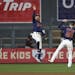 Minnesota Twins' Eddie Rosario, left, Byron Buxton, center, and Max Kepler, right, celebrate on the field after the team's 6-0 win against the Detroit