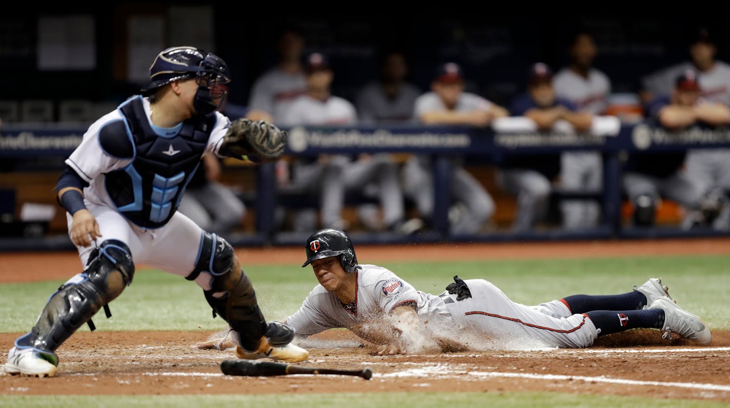 Minnesota Twins' Ehire Adrianza slides home safely ahead of the tag by Tampa Bay Rays catcher Jesus Sucre on a two-run single by Eduardo Escobar during the fifth inning of a baseball game Wednesday, Sept. 6, 2017, in St. Petersburg, Fla. (AP Photo/Chris O'Meara)