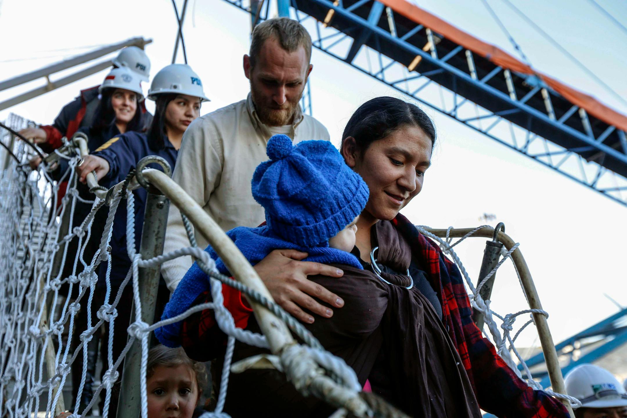 Hannah Gastonguay, holding her baby Rahab, is followed by her husband Sean and the couple's 3-year-old daughter Ardith, as they disembark in the port city of San Antonio, Chile, Friday, Aug. 9, 2013. The northern Arizona family was lost at sea for weeks in an ill-fated attempt to leave the U.S. over what they consider government interference in religion. But just weeks into their journey the Gastonguays hit a series of storms that damaged their small boat, leaving them adrift for weeks. They wer