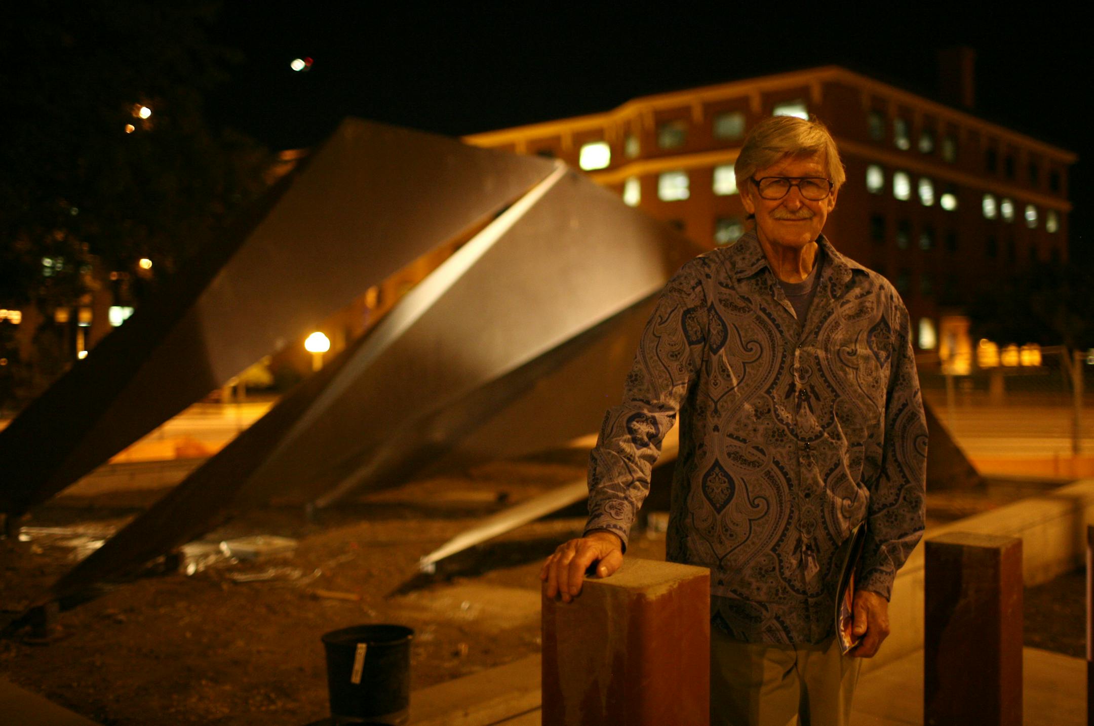 Sculptor Charles Ginnever with his 1966 piece, "Protagoras" Wednesday night after it was reinstalled on the plaza outside the Warren E. Burger Federal Building in St. Paul.