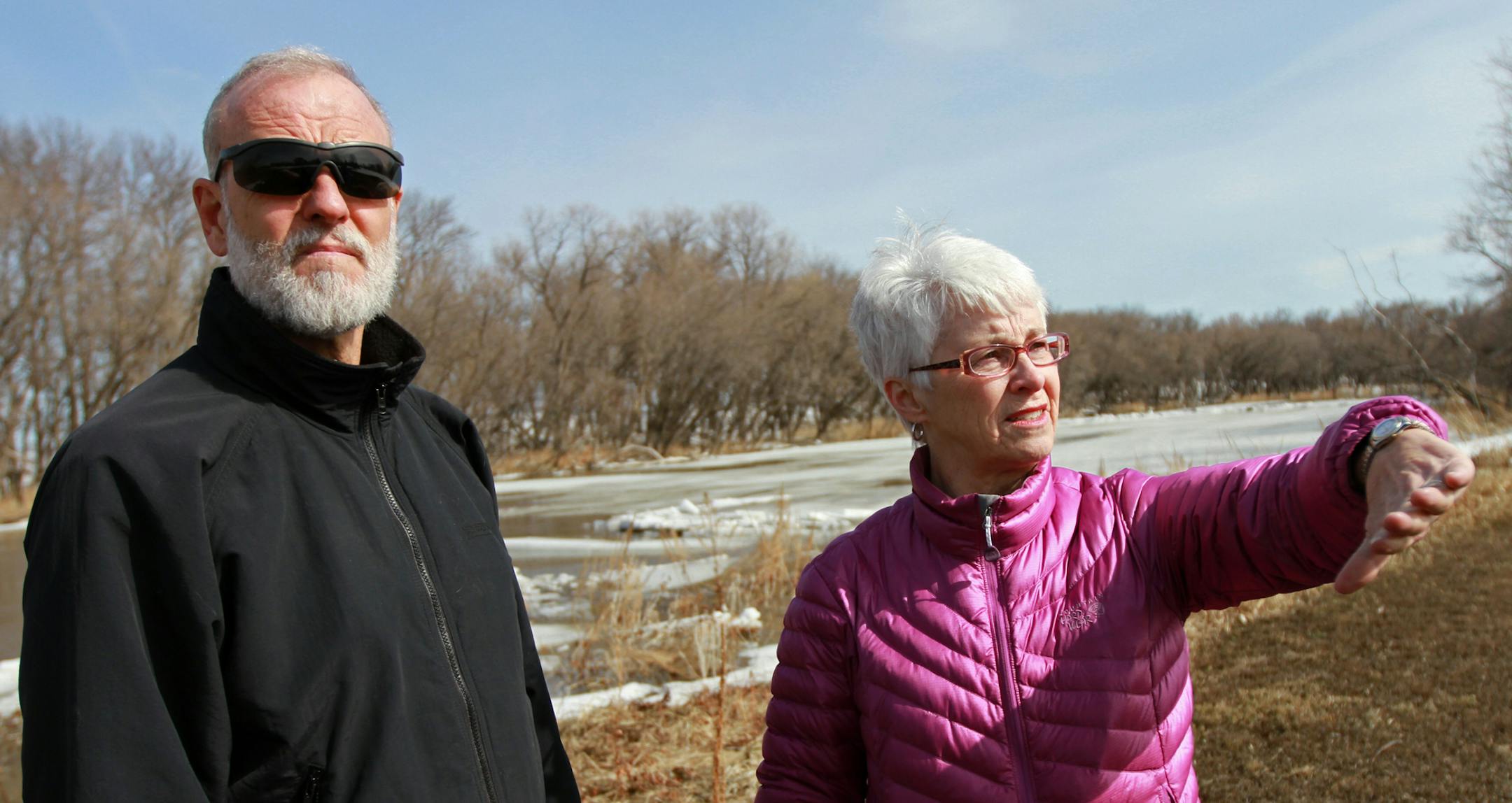 Tom and Mary Moberg stand on the riverfront shore behind their home on River Drive South in Fargo, North Dakota on Thursday, April 25, 2013. The Mobergs bought the house in 2003 after they learned the house did not take on water in the 1997 flood. Although they love living next to the river, after fighting floods in 2009, 2010, 2011 and 2013, they will accept the city's offer to purchase the home for 110% of its current value and will move elsewhere in Fargo. The city will then auction the house