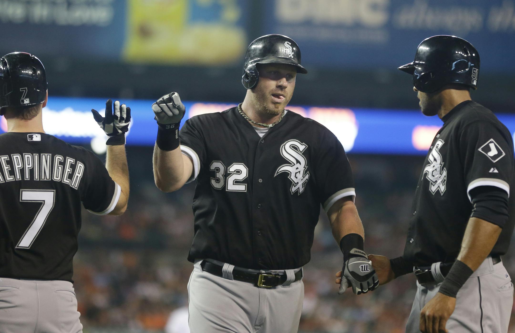 Chicago White Sox first baseman Adam Dunn is met at home after his two-run home run during the eighth inning of a baseball game against the Detroit Tigers in Detroit, Tuesday, July 9, 2013. (AP Photo/Carlos Osorio) ORG XMIT: MIN2013080818295127