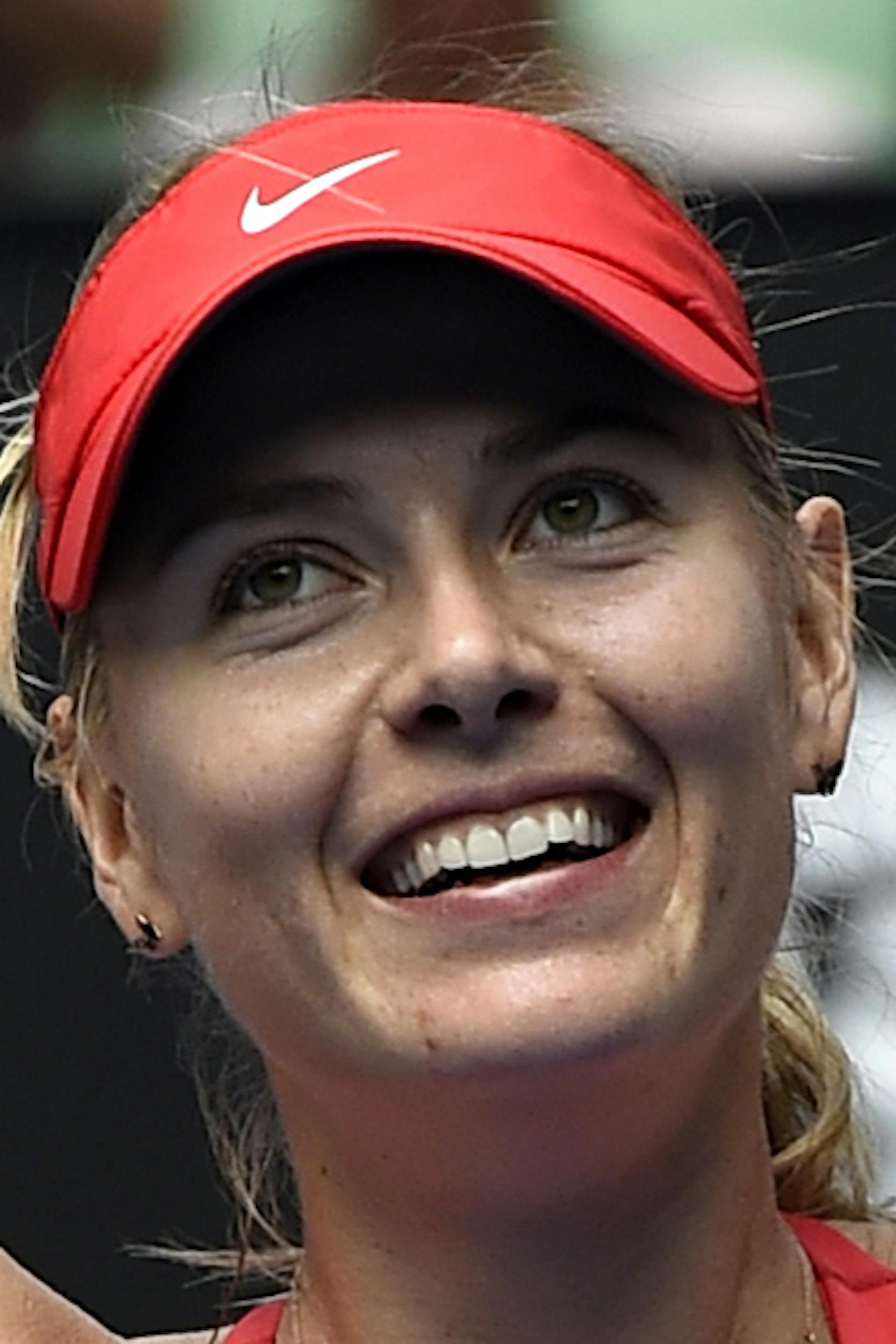 Maria Sharapova of Russia celebrates after defeating her compatriot Ekaterina Makarova in their semifinal match at the Australian Open tennis championship in Melbourne, Australia, Thursday, Jan. 29, 2015. (AP Photo/Andy Brownbill)