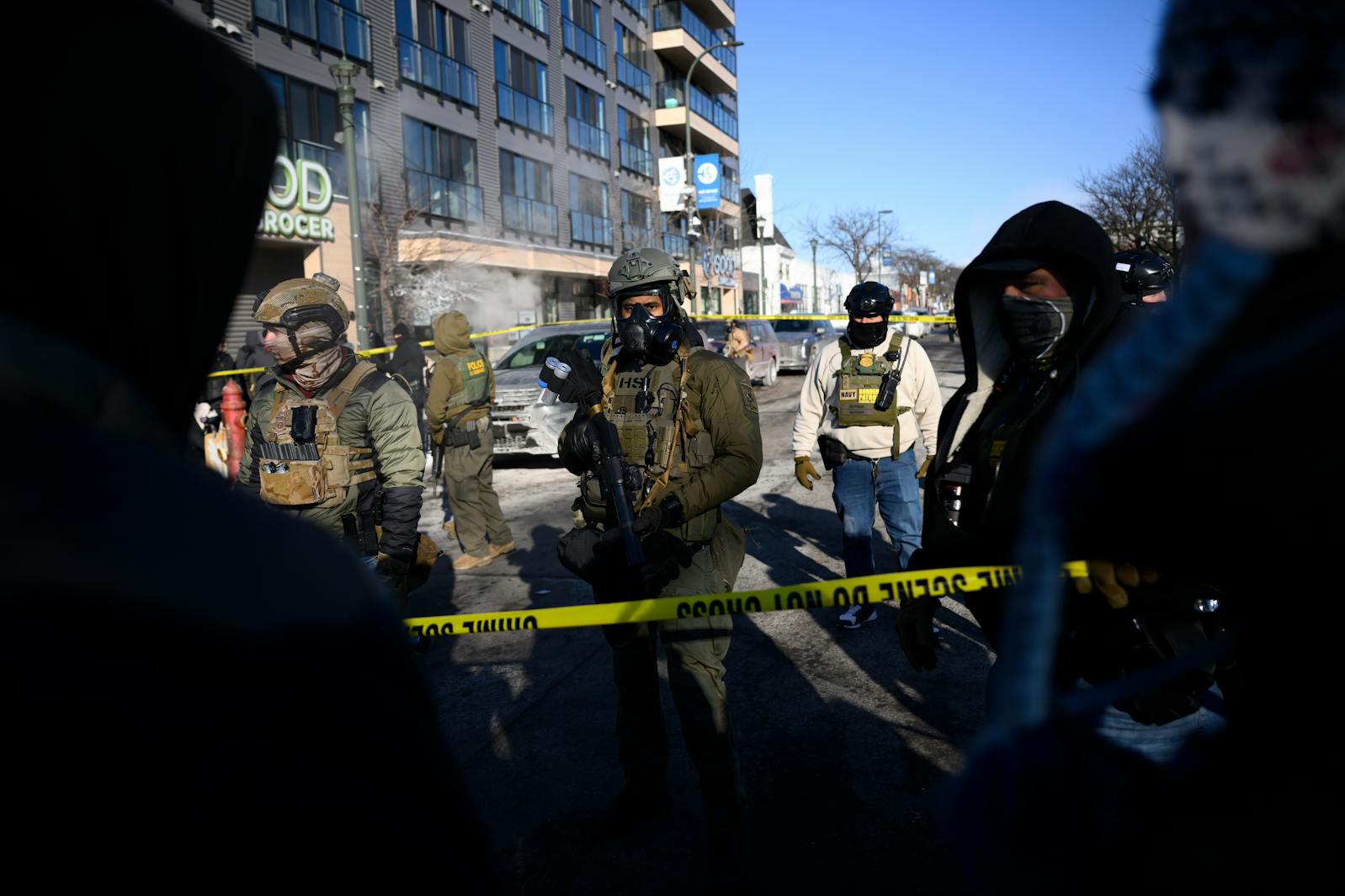 Officers with Homeland Security Investigations and the U.S. Border Patrol face off with protesters on Nicollet Avenue near W. 27th Street hours after federal agents fatally shot Alex Pretti nearby on Jan. 24 in Minneapolis.