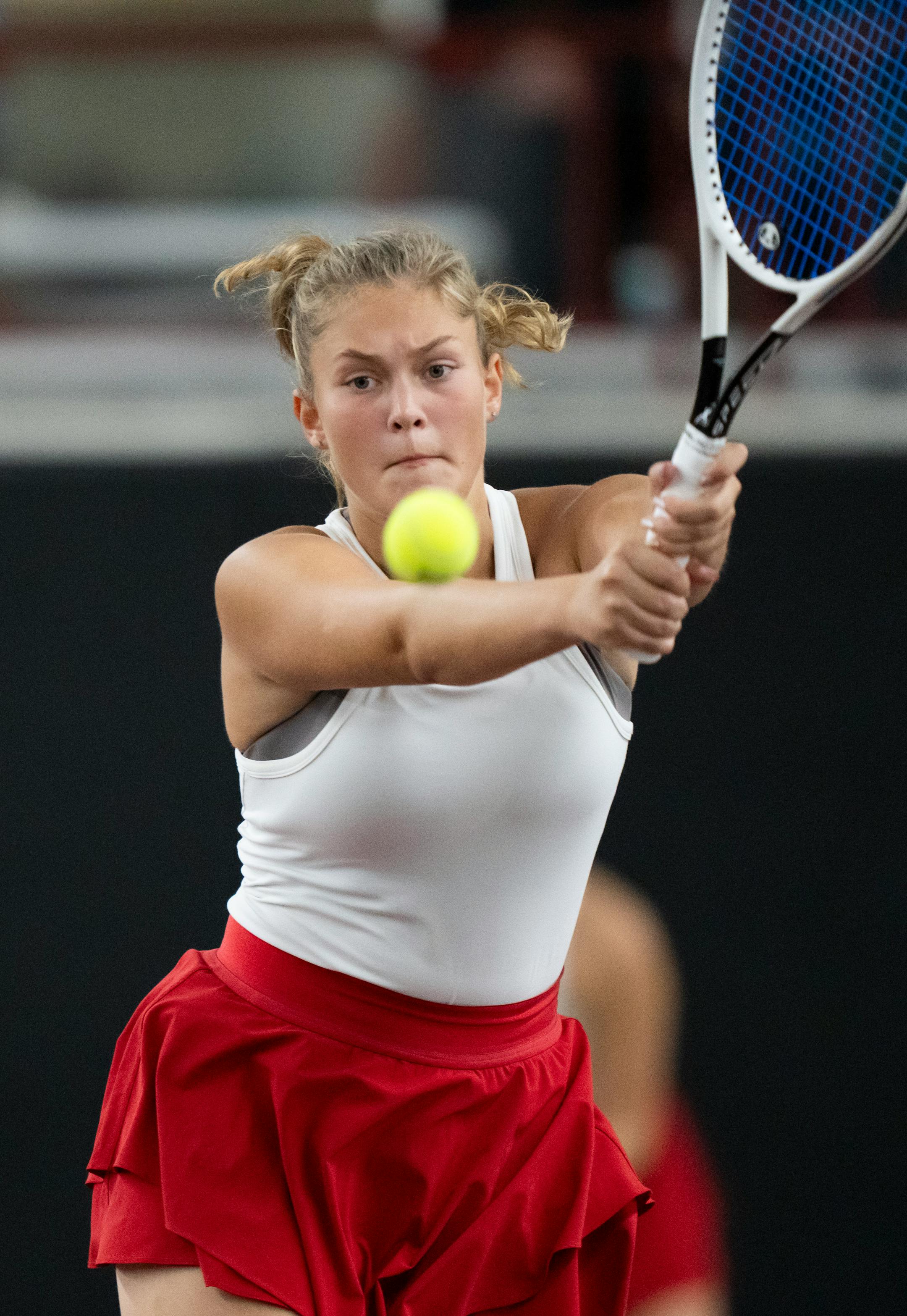 Elk River's first doubles player Leah Skoggquist-Berg hits the ball while playing with Delancy Lundquist against Maple Grove during the Class 2A team girls tennis quarterfinals at Baseline Tennis Center at the University of Minnesota.