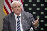 FILE - In this July 8, 2019 file photo, West Virginia Gov. Jim Justice speaks at a roundtable on the opioid epidemic at Cabell-Huntington Health Center in Huntington, WVa. Justice has been frequently criticized by members of both major parties for not spending time at the Charleston statehouse. But perhaps the most forceful condemnation has come from a Democratic lawmaker who has filed three lawsuits that draw on a passage of the state Constitution that says the governor "shall reside at the sea