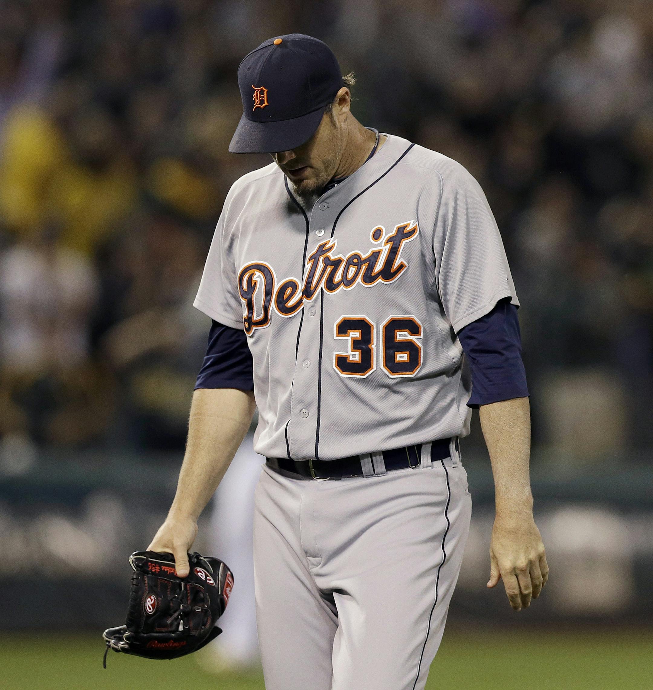 Detroit Tigers pitcher Joe Nathan (36) walks off the field past Oakland Athletics first base coach Tye Waller (46) after allowing a three-run home run to Josh Donaldson during the ninth inning of a baseball game in Oakland, Calif., Wednesday, May 28, 2014. The Athletics won 3-1. (AP Photo/Jeff Chiu)