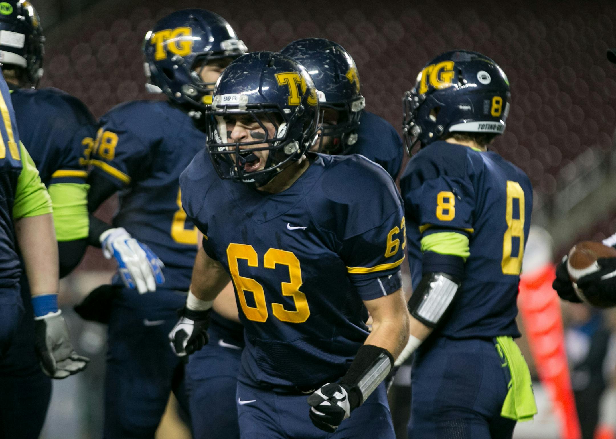 Totino-Grace guard Joseph Weiler (63) celebrates after a touchdown in the first quarter. ] AARON LAVINSKY • aaron.lavinsky@startribune.com Totino-Grace takes on Eden Prairie in the Class 6A Prep Bowl Friday, Nov. 21, 2014 at TCF Bank Stadium.
