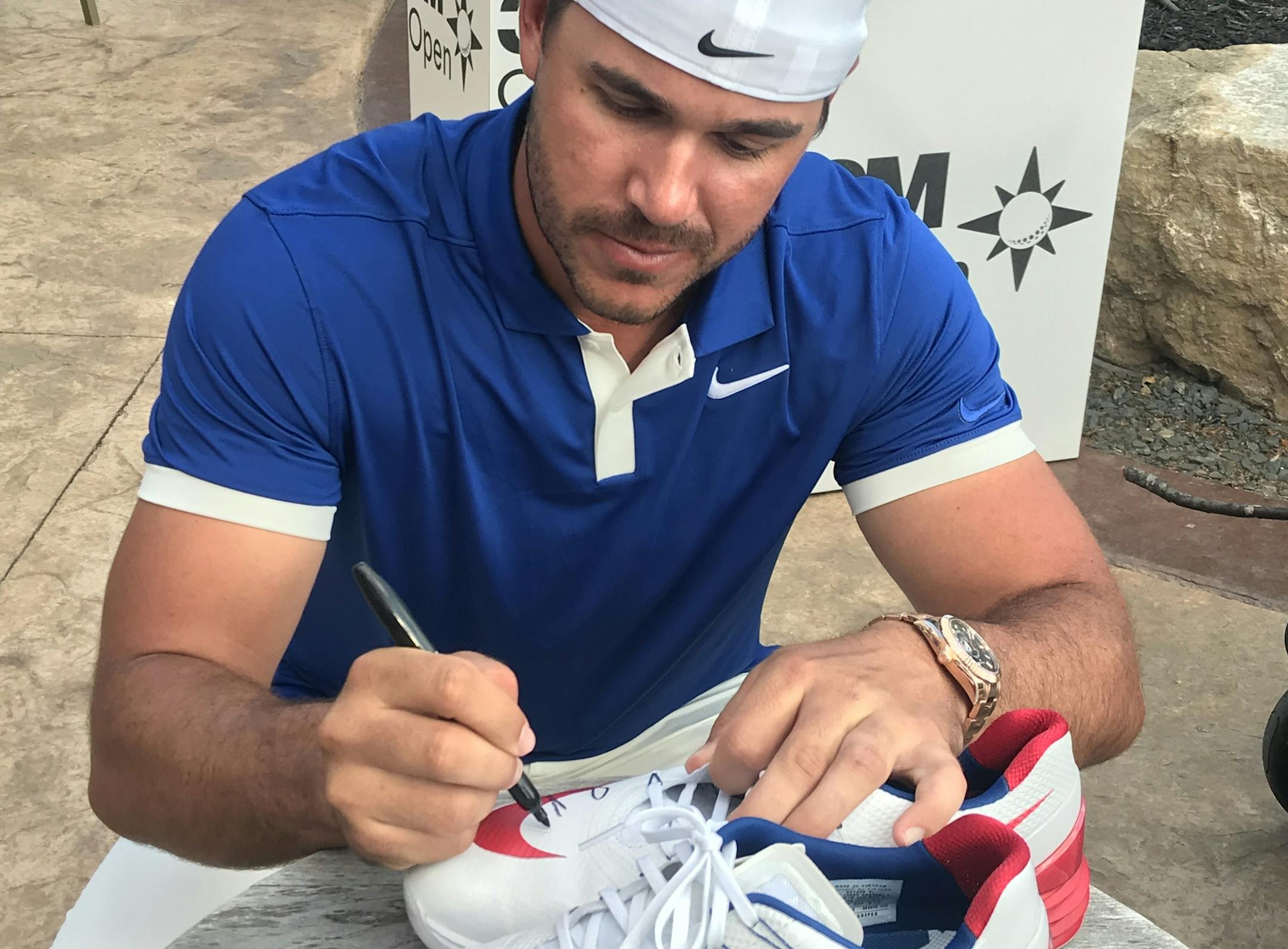 No. 1 Brooks Koepka opened with a 67, then donated his shoes, which also had some Ryder Cup miles on the treads, to charity.