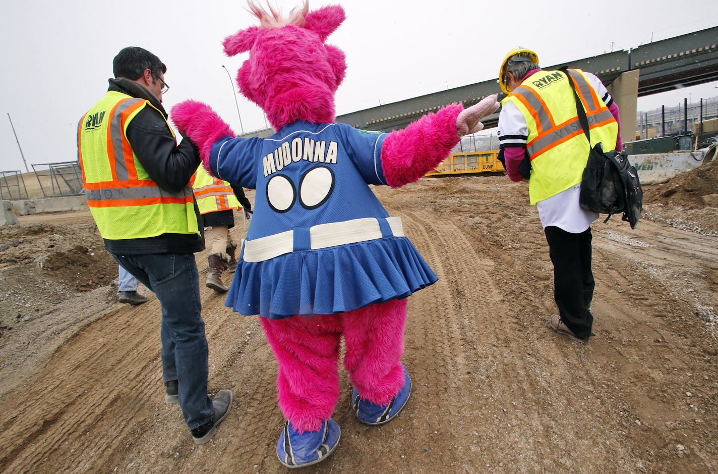 The St. Paul Saints mascot, Mudonna, was given a hand as she toured the site of the new ballpark going up in the Lowertown neighborhood. Below, workers poured cement into the footings for the stadium, which is scheduled to open next spring and will be used by a variety of baseball teams.