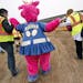The St. Paul Saints mascot, Mudonna, was given a hand as she toured the site of the new ballpark going up in the Lowertown neighborhood. Below, worker