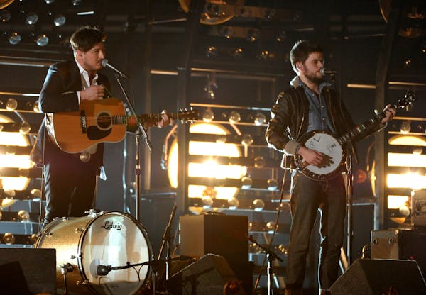 Marcus Mumford, left, and Winston Marshall, of musical group Mumford & Sons, perform at the 55th annual Grammy Awards on Sunday, Feb. 10, 2013, in Los