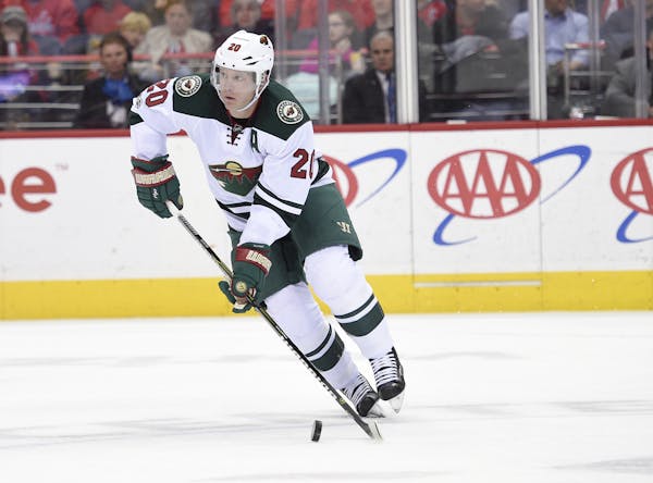 Minnesota Wild defenseman Ryan Suter (20) skates with the puck during the first period of an NHL hockey game against the Washington Capitals, Tuesday,