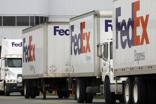 FedEx trucks unload in Anchorage, Alaska Wednesday, Sept. 16, 2009. FedEx, on Thursday, reported that quarterly earnings have fallen 53 percent over last year. The company said it plans to raise U.S. domestic and export shipping rates by 5.9 percent for starting Jan. 4, 2010.