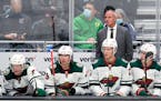 Minnesota Wild head coach Dean Evason stands behind the bench during the second period of the team's NHL hockey game against the Seattle Kraken, Thurs