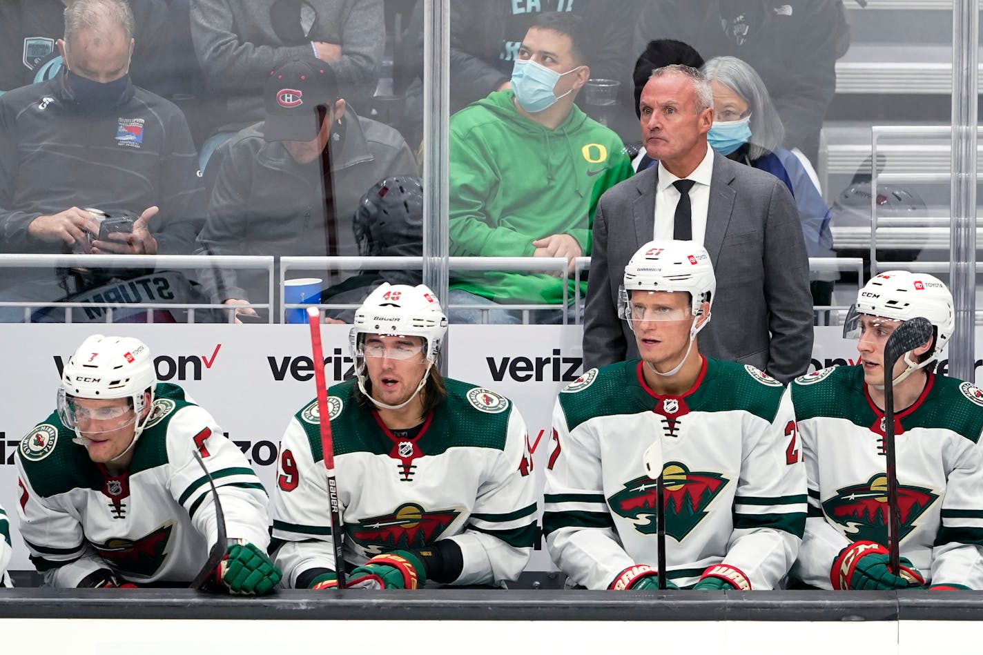 Minnesota Wild head coach Dean Evason stands behind the bench during the second period of the team's NHL hockey game against the Seattle Kraken, Thursday, Oct. 28, 2021, in Seattle. (AP Photo/Ted S. Warren)