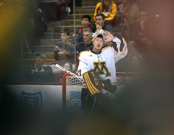 University of Minnesota goalie Eric Schierhorn (37) looked up to watch the replay after being scored on for the second time of the game by Vermont for
