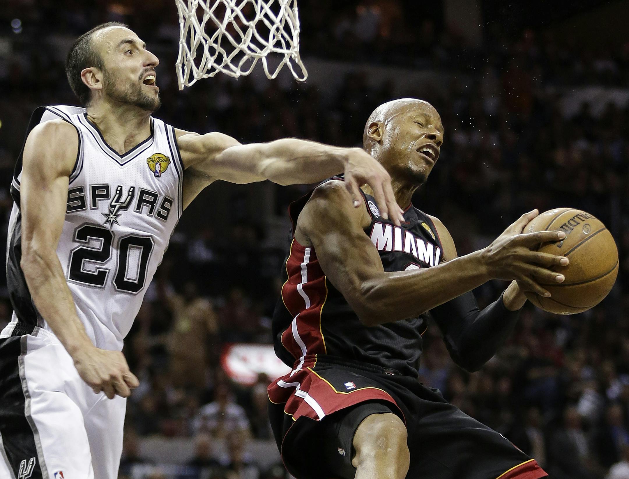 Miami Heat's Ray Allen (34) tries to shoot against San Antonio Spurs' Manu Ginobili (20), of Argentina, during the second half at Game 5 of the NBA Finals basketball series, Sunday, June 16, 2013, in San Antonio. The San Antonio Spurs won 114-104. (AP Photo/Eric Gay)