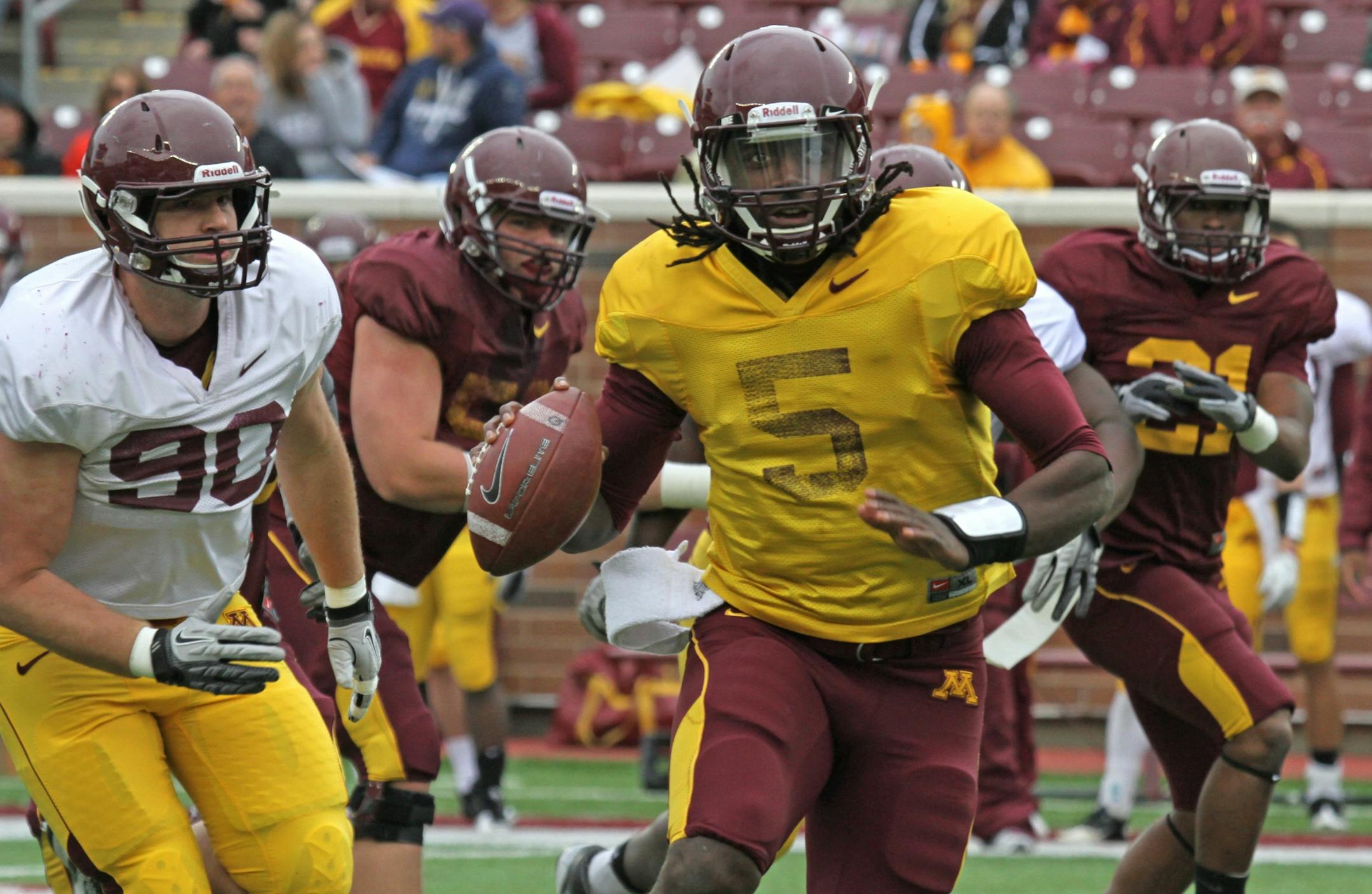(center) Maroon roster quarterback MarQueis Gray ran with the ball as he looked for an open receiver, as the Gophers wrapped up spring football practice with the spring game at TCF Bank Stadium on 4/21/12.
