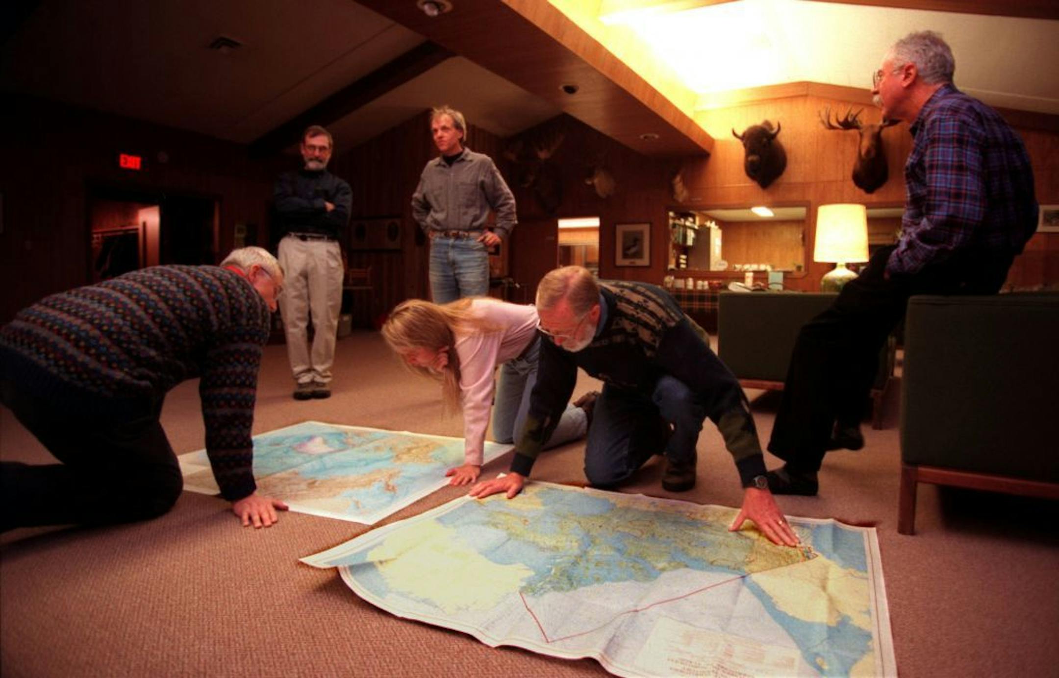 Folks reviewing books at nature center -- Dan Willins of Scandia, Bill Simpson of Marine0nSt. Croix, Tom Anderson of North Branch, Nancy Boulet of Marine on St. Croix, Lavayne Dupslaff of Scandia, and Dick Gordon of Scandia look over detailed maps of the Arctic region that they as a group discussed in a book club review at Warner Nature Center near Marine on St. Croix.