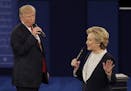 Republican presidential nominee Donald Trump and Democratic presidential nominee Hillary Clinton speak during the second presidential debate at Washin