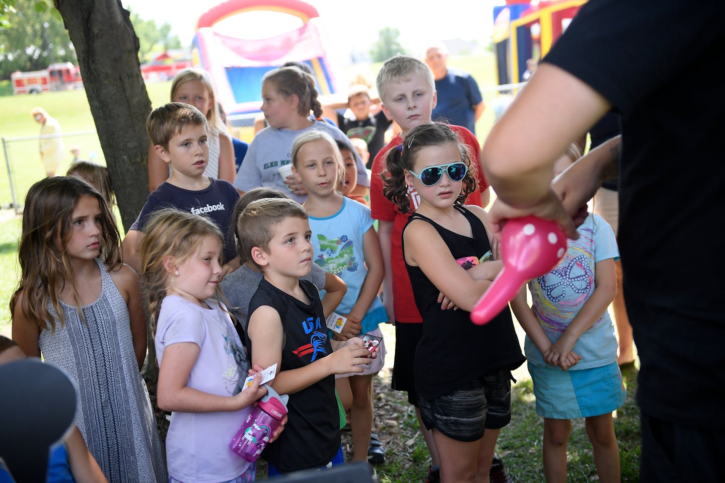 Children were transfixed at the ballon twisting skills of Scott Nichols, of south Minneapolis, as he performed at the Elko New Market 10-year celebration of the city's merger in August. Nichols performs by the name "The Amazing Scott." Almost all of the children in attendance were born after the city's merger. ] AARON LAVINSKY &#xef; aaron.lavinsky@startribune.com It's been 10 years since Elko and New Market merged into the small affluent suburb of Elko New Market, yet residents seem to be havin