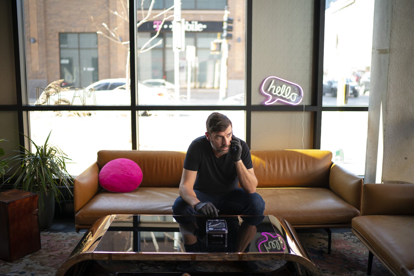 Tommy Stone, bar manager of the Moxy Hotel in Uptown, checked in at home while he was preparing the lobby bar for temporary closure with his coworkers Tuesday afternoon. ] JEFF WHEELER &#x2022; Jeff.Wheeler@startribune.com During a time when business would usually start to grow at Twin Cities hotels, occupancy numbers have fallen to unprecedentedly low numbers, between 5 to 10 percent, forcing some hospitality companies to furlough hundreds of employees. The Moxy Hotel in Uptown has a handful of