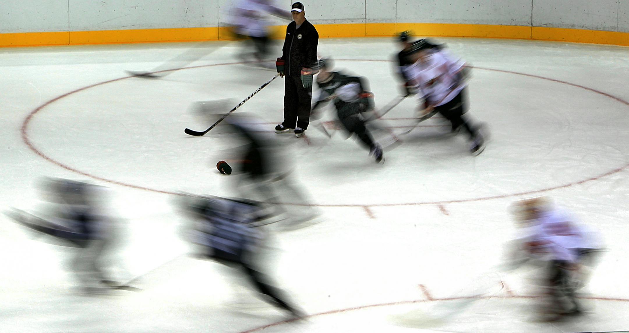 Assistant coach Rick Wilson was surrounded by a swirl of activity as players sped past him during a skating drill.