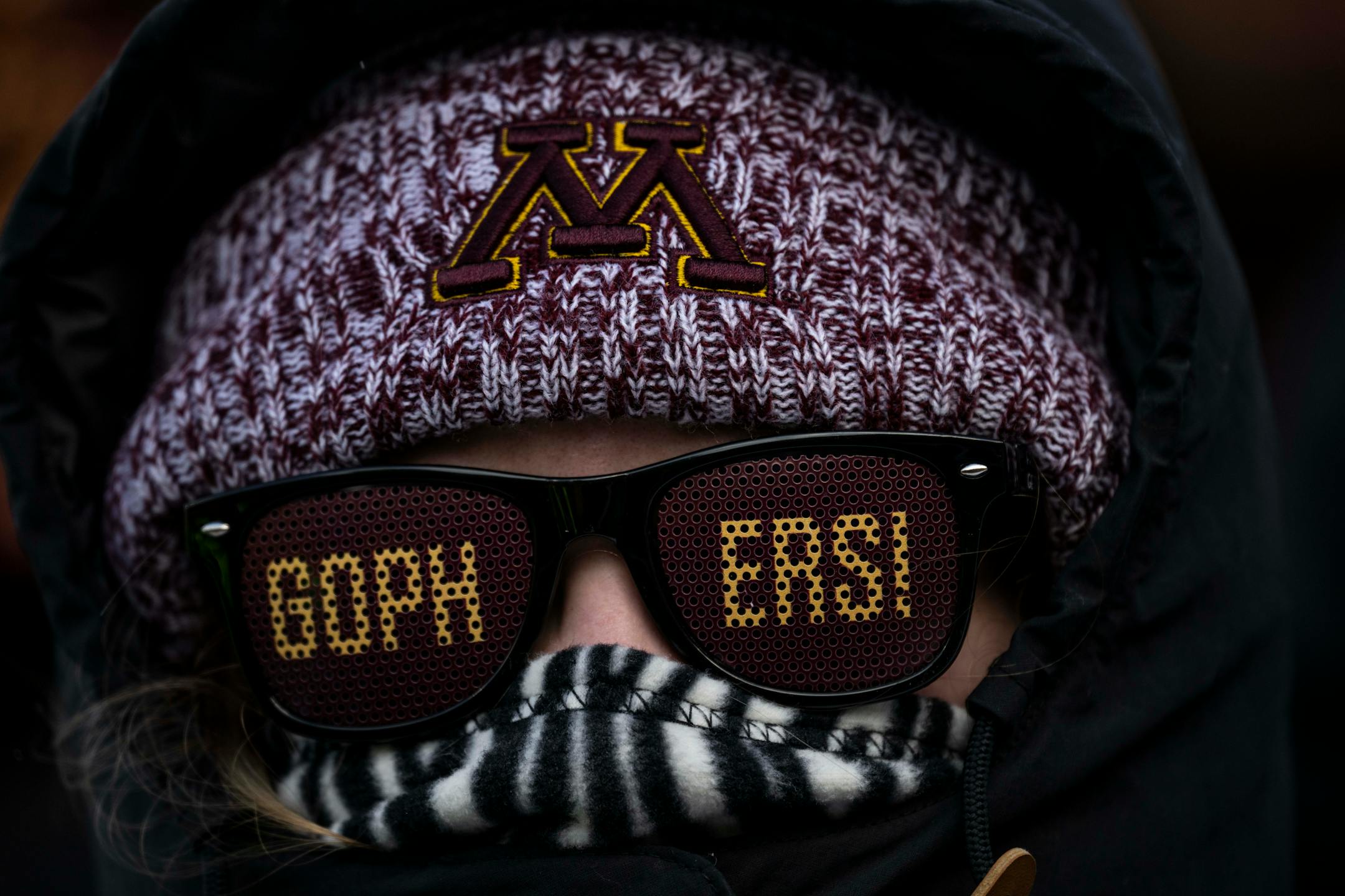 A gophers fan is bundled up to beat the cold before the start.