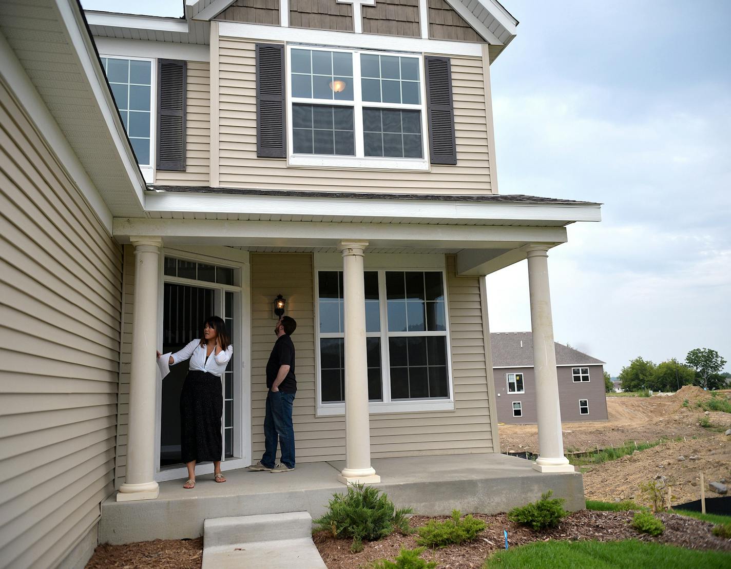 Nate and Linda Rose, both 32, tour a new-construction home in Shakopee's Dakota Crossing with Edina Realty Real Estate Agdent, Derek Jopp. ] (SPECIAL TO THE STAR TRIBUNE/BRE McGEE) **Nate Rose (32, right), Linda Rose (32, left), Derek Jopp (not pictured, Real Estate Agent)