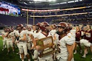 Stewartville players celebrate with their trophy after defeating Annandale in the state Class 3A championship football game at U.S. Bank Stadium in Mi