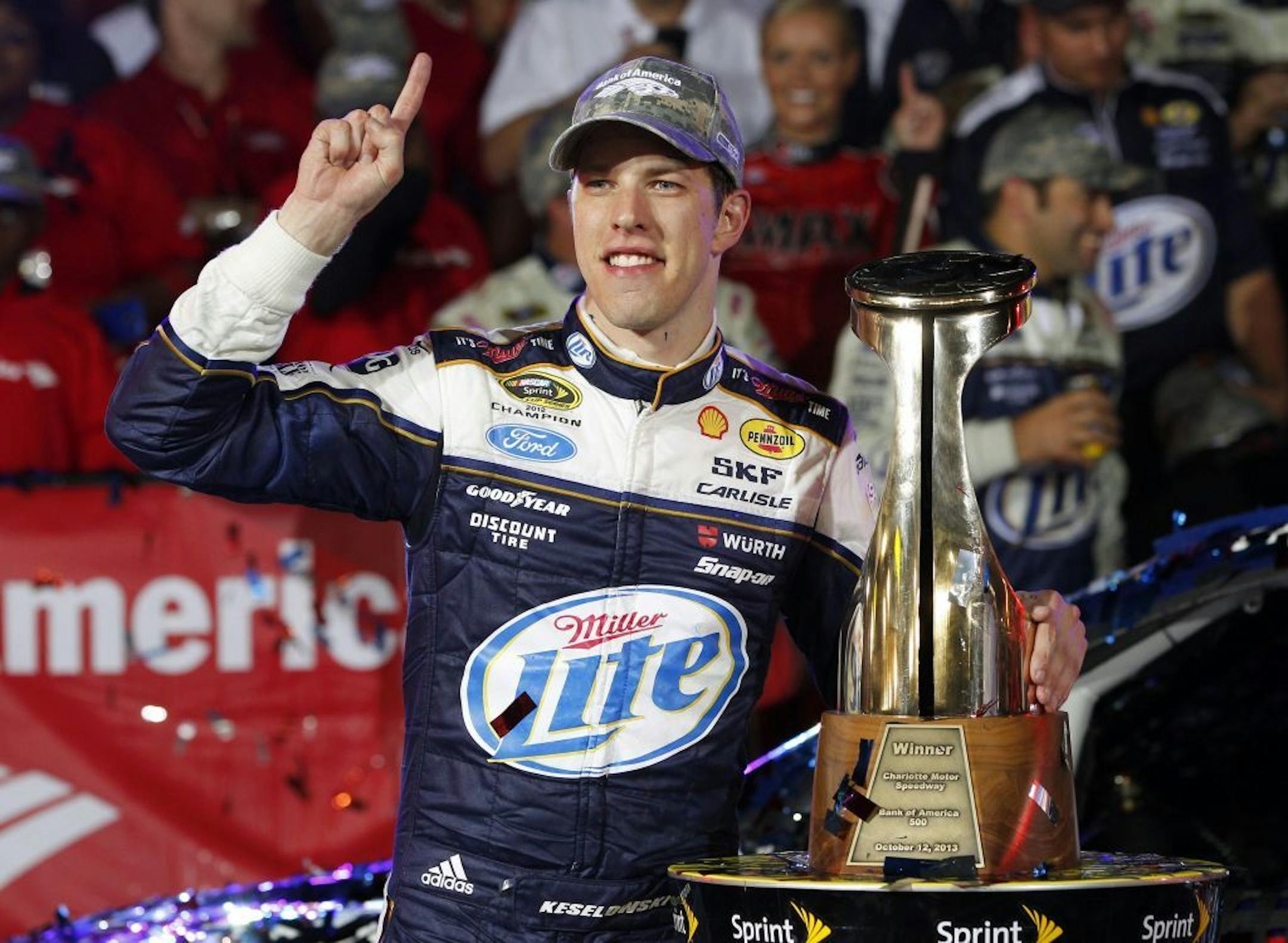 Brad Keselowski celebrates in Victory Lane with the trophy after winning the NASCAR Sprint Cup Series auto race at Charlotte Motor Speedway in Concord, N.C., Saturday, Oct. 12, 2013.