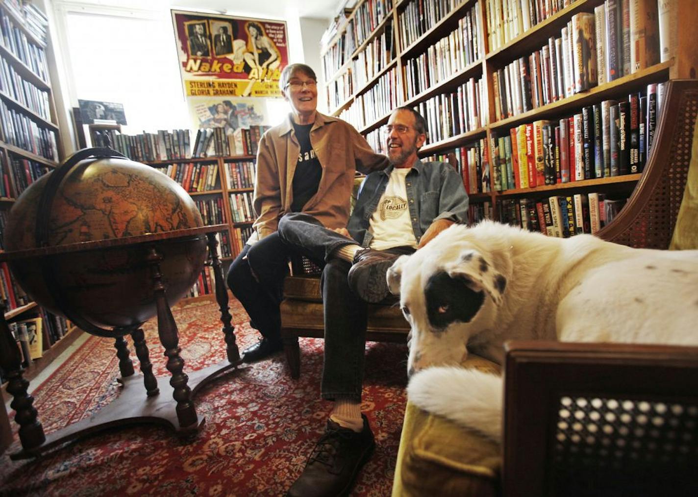 Husband-and-wife co-owners of Once Upon a Crime, Pat Frovarp and Gary Shulze, relaxed in a cozy reading corner of the store's annex, with their beloved border collie mix, Shamus.